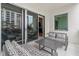 Private balcony with sliding glass doors and outdoor seating at 711 S Palm Ave # 303, Sarasota, FL 34236