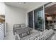 Relaxing balcony featuring sliding glass doors and outdoor furniture at 711 S Palm Ave # 303, Sarasota, FL 34236