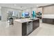 Modern kitchen with island, stainless steel appliances and open living area view at 711 S Palm Ave # 303, Sarasota, FL 34236