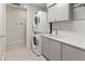 Modern laundry room with stacked washer and dryer, and ample storage at 711 S Palm Ave # 303, Sarasota, FL 34236