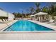Relaxing pool area with multiple lounge chairs and a shaded seating area at 711 S Palm Ave # 303, Sarasota, FL 34236