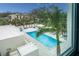 Inviting community pool with lounge chairs and lush landscaping at 711 S Palm Ave # 303, Sarasota, FL 34236