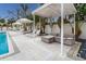 Poolside lounge area with comfortable seating and shade umbrellas at 711 S Palm Ave # 303, Sarasota, FL 34236