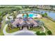 Aerial view of community clubhouse, pool, and landscaping at 7486 Divot Loop # 7486, Bradenton, FL 34202