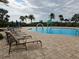 Resort-style community pool with lounge chairs at 7486 Divot Loop # 7486, Bradenton, FL 34202