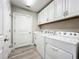 Bright laundry room with washer, dryer, and ample cabinetry at 7486 Divot Loop # 7486, Bradenton, FL 34202