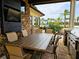 Outdoor kitchen with large table, grill, and TV at 7486 Divot Loop # 7486, Bradenton, FL 34202