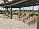 Enjoy the shade under this pergola with comfortable loungers near the pool at 7486 Divot Loop # 7486, Bradenton, FL 34202