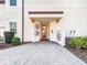 Private entrance with brick pavers and tropical landscaping at 7486 Divot Loop # 7486, Bradenton, FL 34202