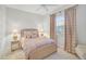 Charming bedroom with wicker bed frame and soft color palette at 7503 Eaton Ct, University Park, FL 34201