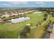 Scenic aerial view of the golf course community featuring ponds, lush greenery, and multi-story residences at 7911 Grand Estuary Trl # 204, Bradenton, FL 34212