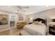 Spacious bedroom with sitting area, ensuite bathroom access, and ceiling fan at 7938 Pinegrove Ct # 12, Sarasota, FL 34238