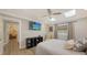 Serene bedroom with large TV, ceiling fan and access to hallway at 7938 Pinegrove Ct # 12, Sarasota, FL 34238