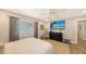 Well lit bedroom with large TV, ceiling fan, and plenty of storage at 7938 Pinegrove Ct # 12, Sarasota, FL 34238
