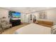 Relaxing bedroom with large TV, sitting area and ensuite access at 7938 Pinegrove Ct # 12, Sarasota, FL 34238