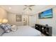 Comfortable bedroom with large TV, ceiling fan, and ensuite bathroom at 7938 Pinegrove Ct # 12, Sarasota, FL 34238