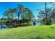 Serene community pond with lush landscaping and water fountain at 7938 Pinegrove Ct # 12, Sarasota, FL 34238