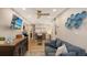 Relaxing den features a sofa, TV, and a stylish media console at 7938 Pinegrove Ct # 12, Sarasota, FL 34238