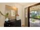 Bright and airy entryway with decorative mirror and console table at 7938 Pinegrove Ct # 12, Sarasota, FL 34238