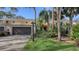 Exterior of charming condo with attached garage and lush landscaping at 7938 Pinegrove Ct # 12, Sarasota, FL 34238