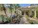 Inviting condo entry with a relaxing patio and tropical landscaping at 7938 Pinegrove Ct # 12, Sarasota, FL 34238