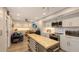 Modern kitchen with stainless steel appliances and a large island for casual dining at 7938 Pinegrove Ct # 12, Sarasota, FL 34238