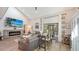 Bright living room with vaulted ceilings, fireplace, and sliding glass doors leading to patio at 7938 Pinegrove Ct # 12, Sarasota, FL 34238