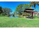 Community picnic area with covered seating and views of a pond at 7938 Pinegrove Ct # 12, Sarasota, FL 34238