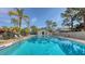 Community pool with lounge chairs and surrounding landscaping at 7938 Pinegrove Ct # 12, Sarasota, FL 34238