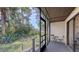 Relaxing screened porch with table and chairs overlooks a lush backyard at 7938 Pinegrove Ct # 12, Sarasota, FL 34238
