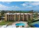 Aerial view of condo complex with pool and tennis courts, near the beach at 8773 Midnight Pass Rd # 205G, Sarasota, FL 34242