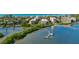 Aerial view of waterfront community with tennis courts, pool, and boat docks at 8773 Midnight Pass Rd # 205G, Sarasota, FL 34242