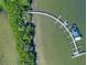 Aerial view of curved dock and mangrove at 8773 Midnight Pass Rd # 205G, Sarasota, FL 34242