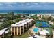 Aerial view of condo complex with oceanfront location, pool and tennis at 8773 Midnight Pass Rd # 205G, Sarasota, FL 34242