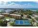 Aerial view showcasing community amenities including tennis courts and a pool at 8773 Midnight Pass Rd # 205G, Sarasota, FL 34242