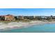 Aerial view of condo building and beach access with ocean views at 8773 Midnight Pass Rd # 205G, Sarasota, FL 34242