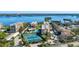 Aerial view of waterfront condo community with pool and tennis courts at 8773 Midnight Pass Rd # 205G, Sarasota, FL 34242