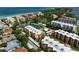 Aerial view highlighting a condo building near tennis courts and a pool at 8773 Midnight Pass Rd # 205G, Sarasota, FL 34242
