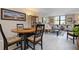 Round dining table with four chairs, in open layout at 8773 Midnight Pass Rd # 205G, Sarasota, FL 34242