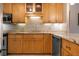 Kitchen features wood cabinets and granite countertops at 8773 Midnight Pass Rd # 205G, Sarasota, FL 34242