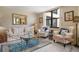 Living room with sofa, armchairs, coffee table, and large window at 8773 Midnight Pass Rd # 205G, Sarasota, FL 34242