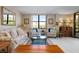 Living room with sofa, armchairs, coffee table, and large window at 8773 Midnight Pass Rd # 205G, Sarasota, FL 34242