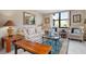 Living room with sofa, armchairs, coffee table, and large window at 8773 Midnight Pass Rd # 205G, Sarasota, FL 34242