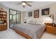 Spacious main bedroom with private balcony access and ceiling fan at 8773 Midnight Pass Rd # 205G, Sarasota, FL 34242