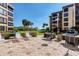 Community patio with grills and lounge chairs at 8773 Midnight Pass Rd # 205G, Sarasota, FL 34242