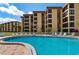 Resort-style pool with building view and lounge chairs at 8773 Midnight Pass Rd # 205G, Sarasota, FL 34242