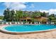 Community pool with lounge chairs and surrounding building at 8773 Midnight Pass Rd # 205G, Sarasota, FL 34242