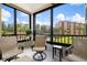 Spacious screened balcony overlooking a landscaped area at 8773 Midnight Pass Rd # 205G, Sarasota, FL 34242