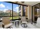 Relaxing screened balcony with patio furniture and scenic view at 8773 Midnight Pass Rd # 205G, Sarasota, FL 34242