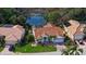 Aerial view of single-Gathering home with tile roof, landscaped yard, and pool at 8960 Huntington Pointe Dr, Sarasota, FL 34238